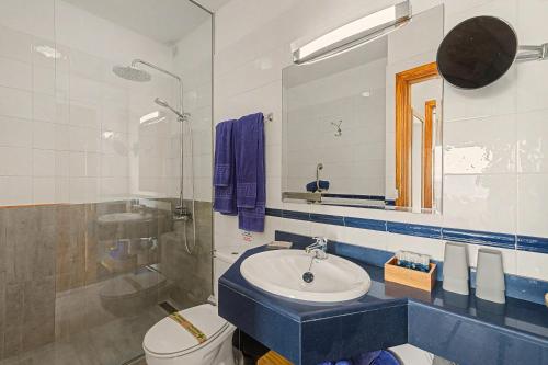 a bathroom with a sink and a toilet and a mirror at Callao Beach 3 in Arrieta