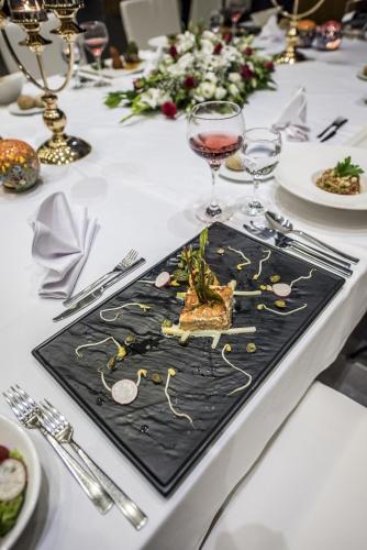 a table with a black plate with food on it at Ramada By Wyndham Cappadocia in Ortahisar