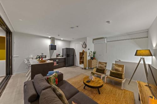 a living room with a couch and a table at Island Time Retreat in Willemstad