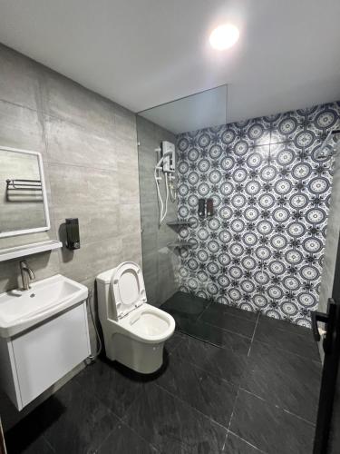 a bathroom with a toilet and a sink at Tanjung Tuan Beach Regency - Hermis Theme 1 Car Park in Kampong Baharu