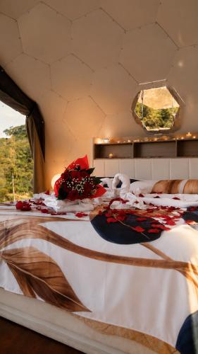 a bed in a room with flowers on it at Palmaria Sky Bubbles Room in Ponza