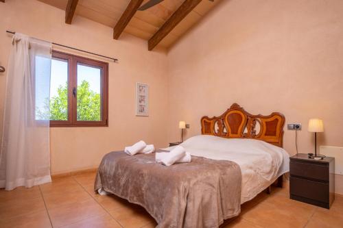 a bedroom with a large bed and a window at Son Fred in Felanitx