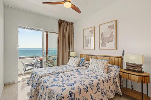 a bedroom with a bed with a view of the ocean at Callao Beach 1 in Arrieta