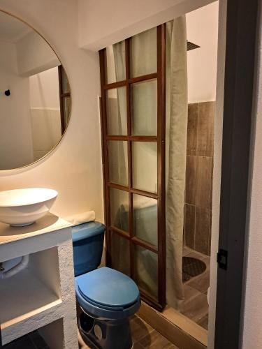 a bathroom with a toilet and a sink and a shower at Casa Puerto Siete8 in Mexico City