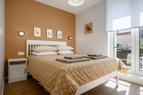 a bedroom with a bed and a window at Maison La Mirabelle in Thann