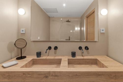 a bathroom with a bath tub with two faucets at La maison de simon in Pietrosella