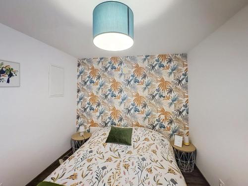 a bedroom with a bed and a wall at Le Nevoy in Nevoy