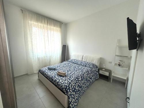 a small bedroom with a bed and a window at Glycine House in Varese