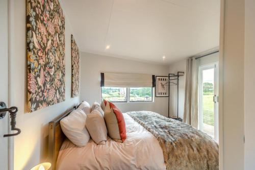 a bedroom with a bed with pillows and a window at 2 Bed in Overton oc-k45280 in Overton