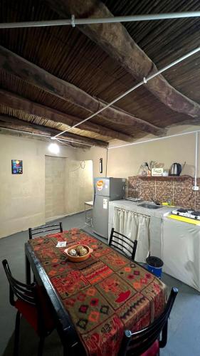 a kitchen with a table with a table cloth on it at Casa Manuel in Tinogasta