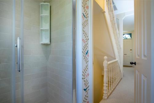 a shower with a glass door in a bathroom at 1 Abiff Place in Sidmouth