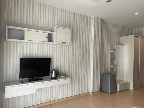 a living room with a flat screen tv on a wall at New Abani in Jomtien Beach