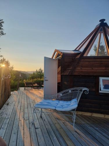 a bench on the deck of a house at Lavvo med glasstak in Svenseid