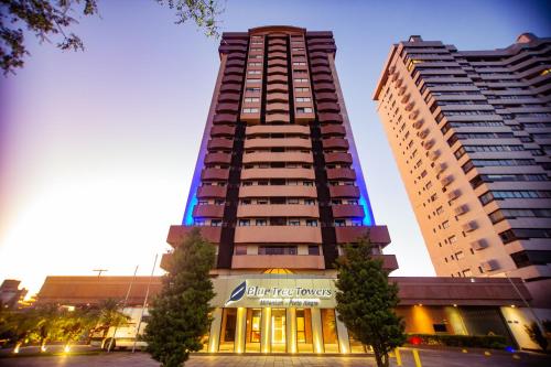a tall building in front of two tall buildings at Blue Tree Towers Millenium Porto Alegre in Porto Alegre