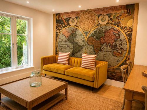a living room with a couch and a map on the wall at Watersmeet Point in Lynmouth