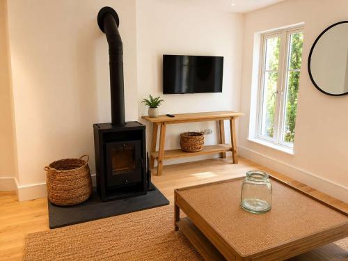 a living room with a fireplace and a tv at Watersmeet Point in Lynmouth