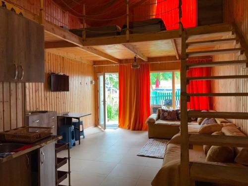 a room with a bunk bed and a living room at Valdi Guest Shekvetili in Shekhvetili