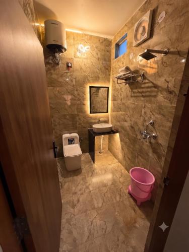 a bathroom with a toilet and a sink at The Amber House - Luxury Boutique Stay in Bani Park, City Center Jaipur in Jaipur