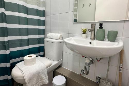 a small bathroom with a sink and a toilet at Vista Laguna Oriente By Andes Plus in Concepción