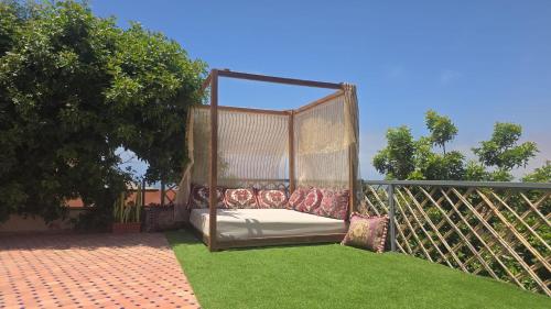 a gazebo sitting on the grass in a yard at Ocean View 6 bed Villa and Pool in Mirleft