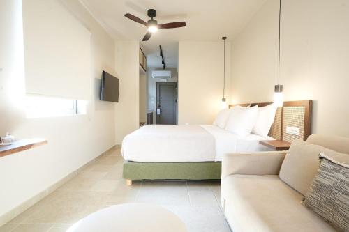 a hotel room with a bed and a couch at Phi Aegina in Agia Marina Aegina