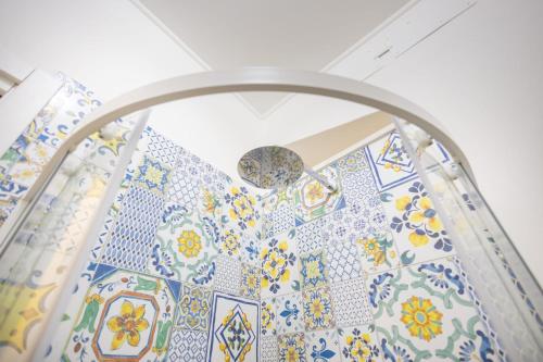 a room with blue and white tiles on the wall at Esmeralda Guest House in Cinisi