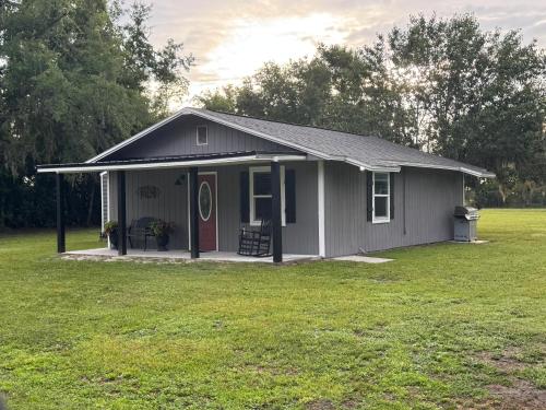 a small house with a green yard at Cherry Cottage in Lake City