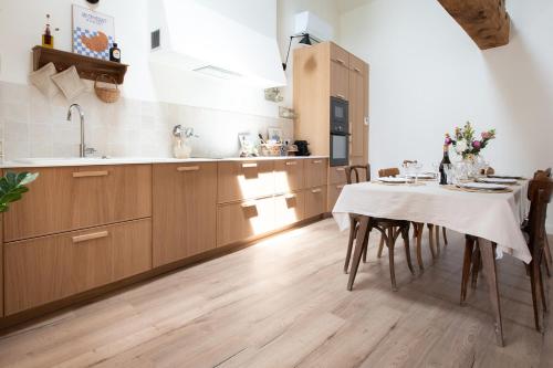 a kitchen with a table with a table cloth on it at Maison de vacances avec cave voûtée entre Lyon et Beaune in Givry