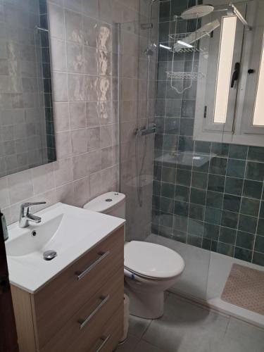 a bathroom with a sink and a toilet and a shower at Cal Jamila in Cubelles