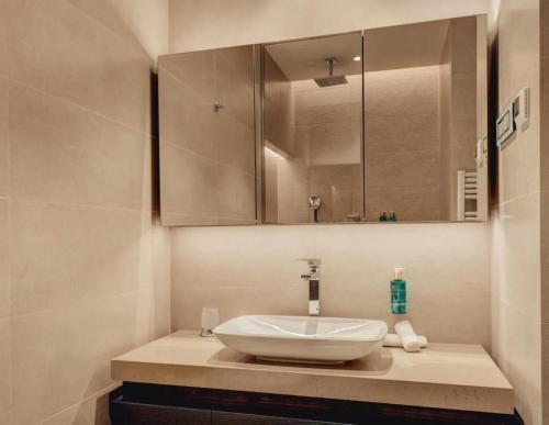 a bathroom with a sink and a mirror at Portonovi Marina in Kumbor