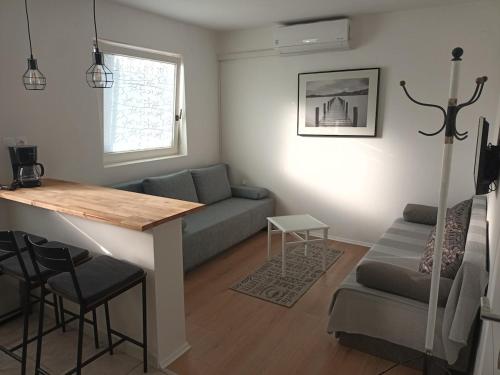 a living room with a couch and a table at Apartman studio in Privlaka
