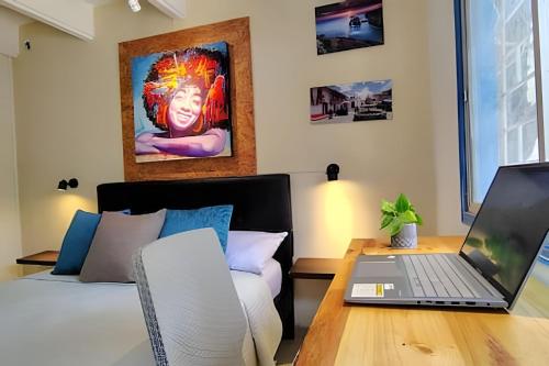 a bedroom with a desk with a laptop on a table at Guadalia Living Smr in Santa Marta