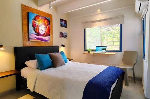 a bedroom with a bed and a desk and a window at Guadalia Living Smr in Santa Marta