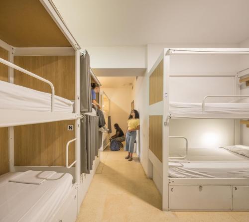 a group of people in a dorm room with bunk beds at UP Hostel Valencia in Valencia