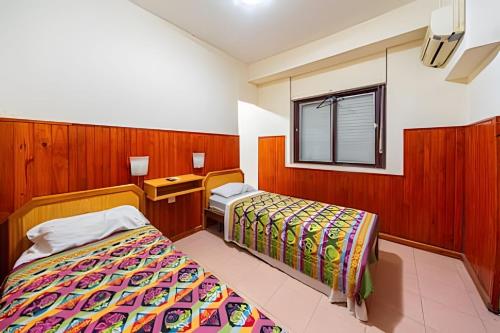 a hotel room with two beds and a window at "Alpha", downtown hotel room in Rosario