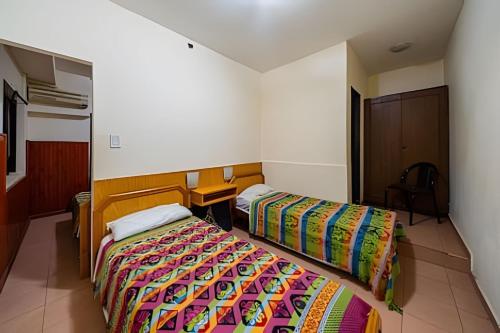 a hotel room with two beds in a room at "Alpha", downtown hotel room in Rosario