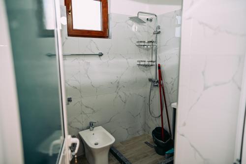 a bathroom with a toilet and a sink at Vila BENE in Pogradec