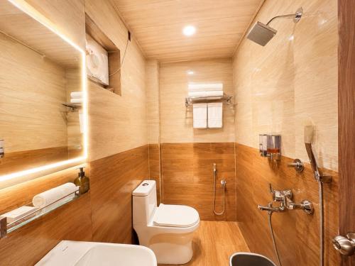 a bathroom with a toilet and a shower at Hotel A One Luxury - Premium Stay Puri Beach in Puri