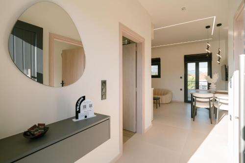 a hallway with a mirror and a dining room at Aether Home in Ammoudia