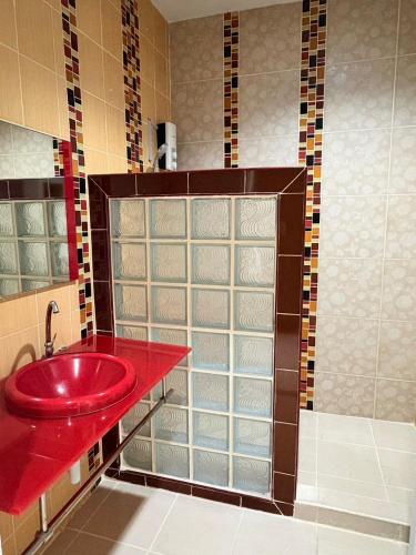 a bathroom with a red sink and a shower at Breezehill Khao Kho Hotel in Khao Kho