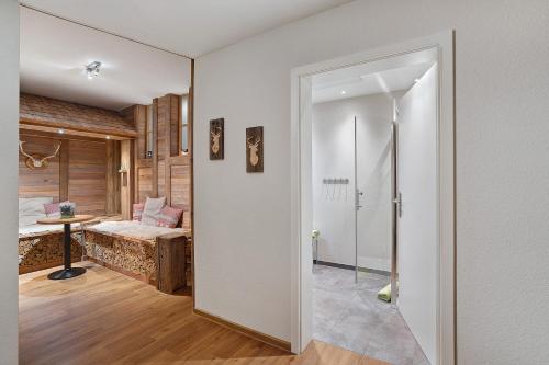 a room with a bed and a door leading to a bedroom at Azuria Schwarzwald Loft in Kappelrodeck