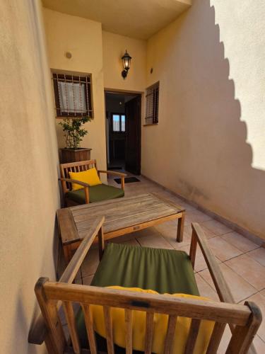 a living room with a wooden table and chairs at Fiori Di Santa Giulia in Porto-Vecchio