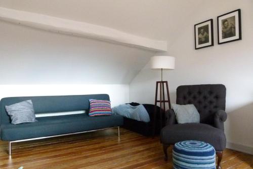 a living room with a couch and a chair at Wetterdelle in Heers