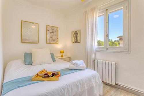 a bedroom with a bed with a tray of food on it at Chalet Irene by dracmallorca in Santanyi