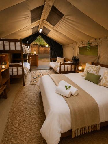 a bedroom with two beds in a tent at Moz Inn - Coconut View Resort in Lopes