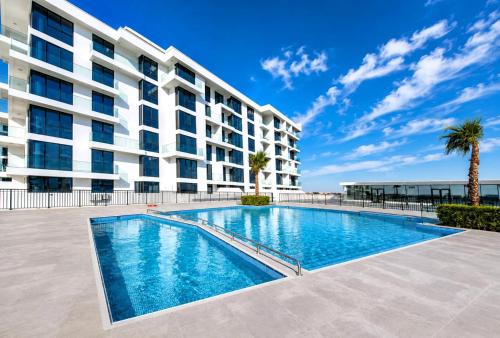 a swimming pool in front of a building at Luxury Sea Living in Sharjah