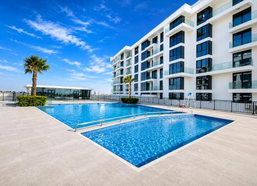 a swimming pool in front of a building at Luxury Sea Living in Sharjah
