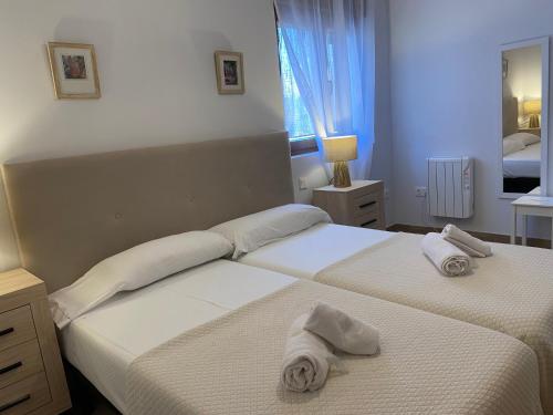 two beds in a bedroom with towels on them at R2R - Apartamentos Prellezo - C20C03 in Prellezo