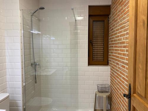 a glass shower in a bathroom with a stool at R2R - Apartamentos Prellezo - C20C03 in Prellezo