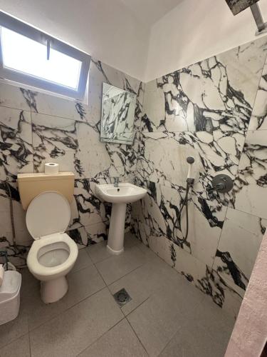 a bathroom with a toilet and a sink at Vila Manuel in Shëngjin